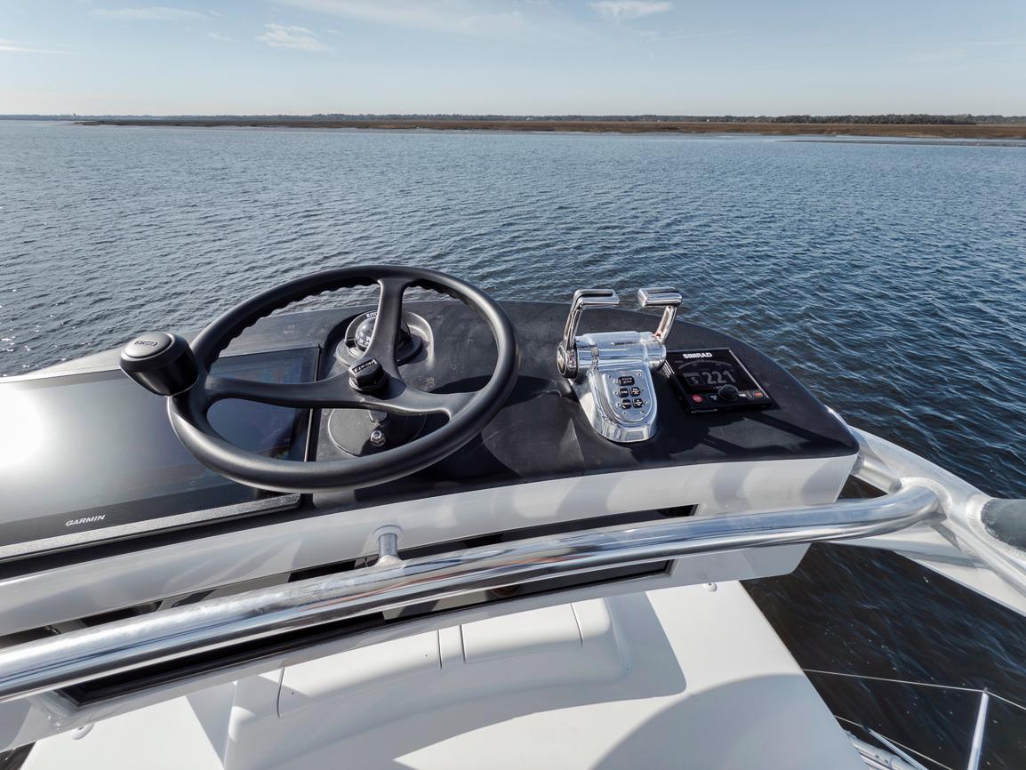 Garlington-44 Express 1996 -FL-US-Helm of 1996 Garlington 44 Express yacht with steering wheel and controls, overlooking calm waters.-9651424 | Thumbnail