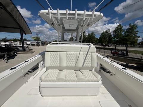 2022 Invincible 33 Catamaran with cushioned seating and T-top under a clear sky.