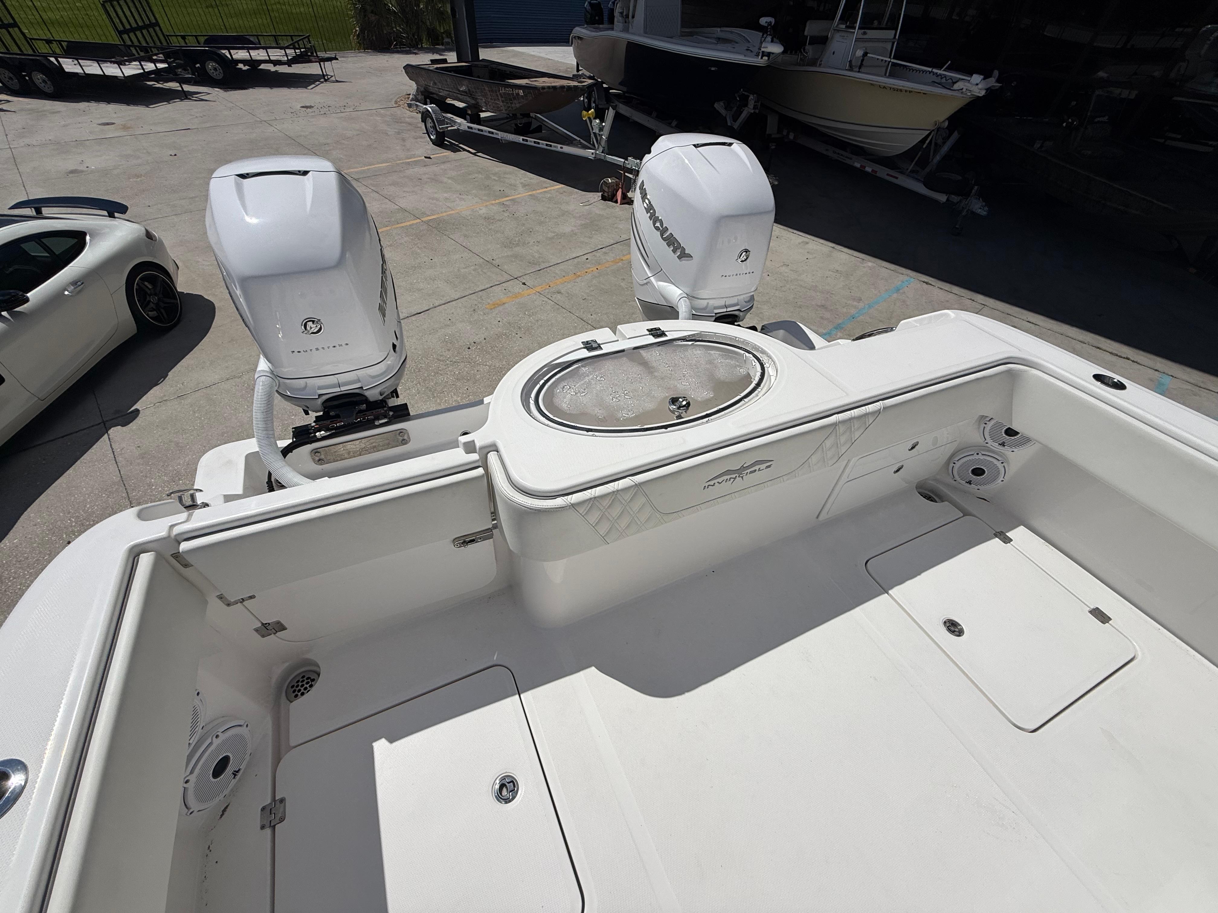 2022 Invincible 33 Catamaran with dual outboard engines, docked in a marina.