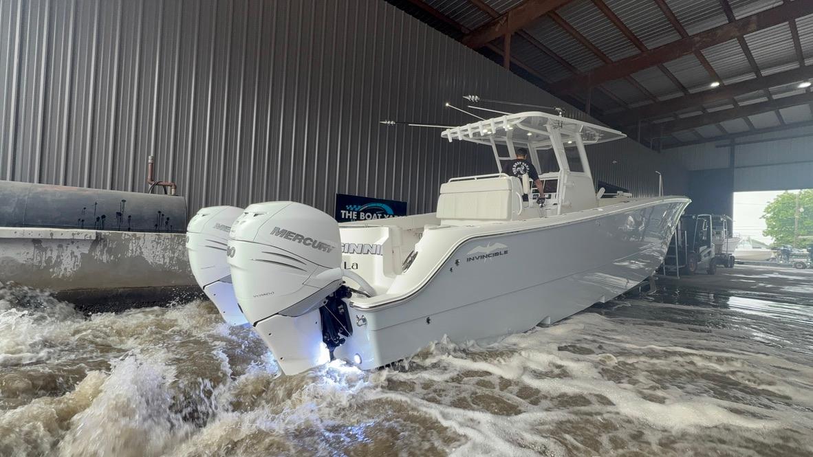 2022 Invincible 33 Catamaran with twin Mercury engines in a boatyard.
