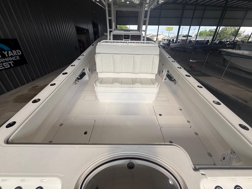 2022 Invincible 33 Catamaran interior with white seating and storage compartments.
