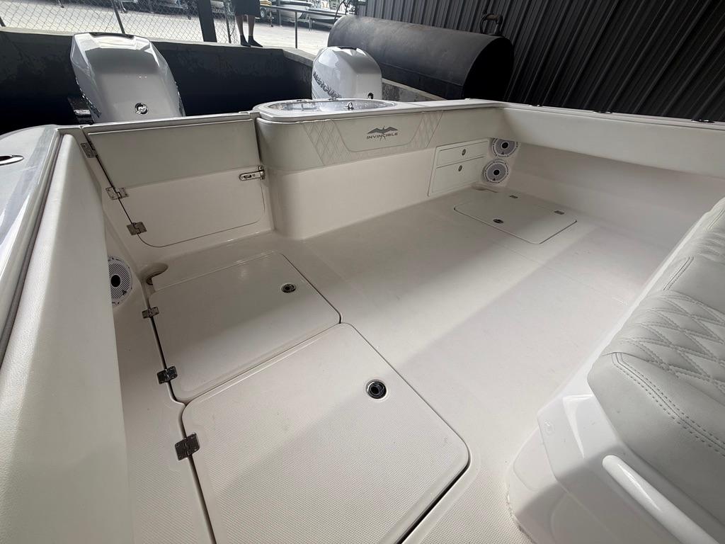 2022 Invincible 33 Catamaran interior with storage compartments and seating area.