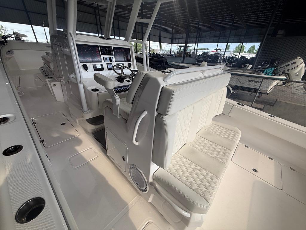 2022 Invincible 33 Catamaran interior with modern helm and seating in a covered marina.