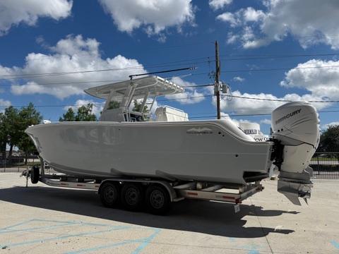 2022 Invincible 33 Catamaran on trailer under blue sky with clouds.