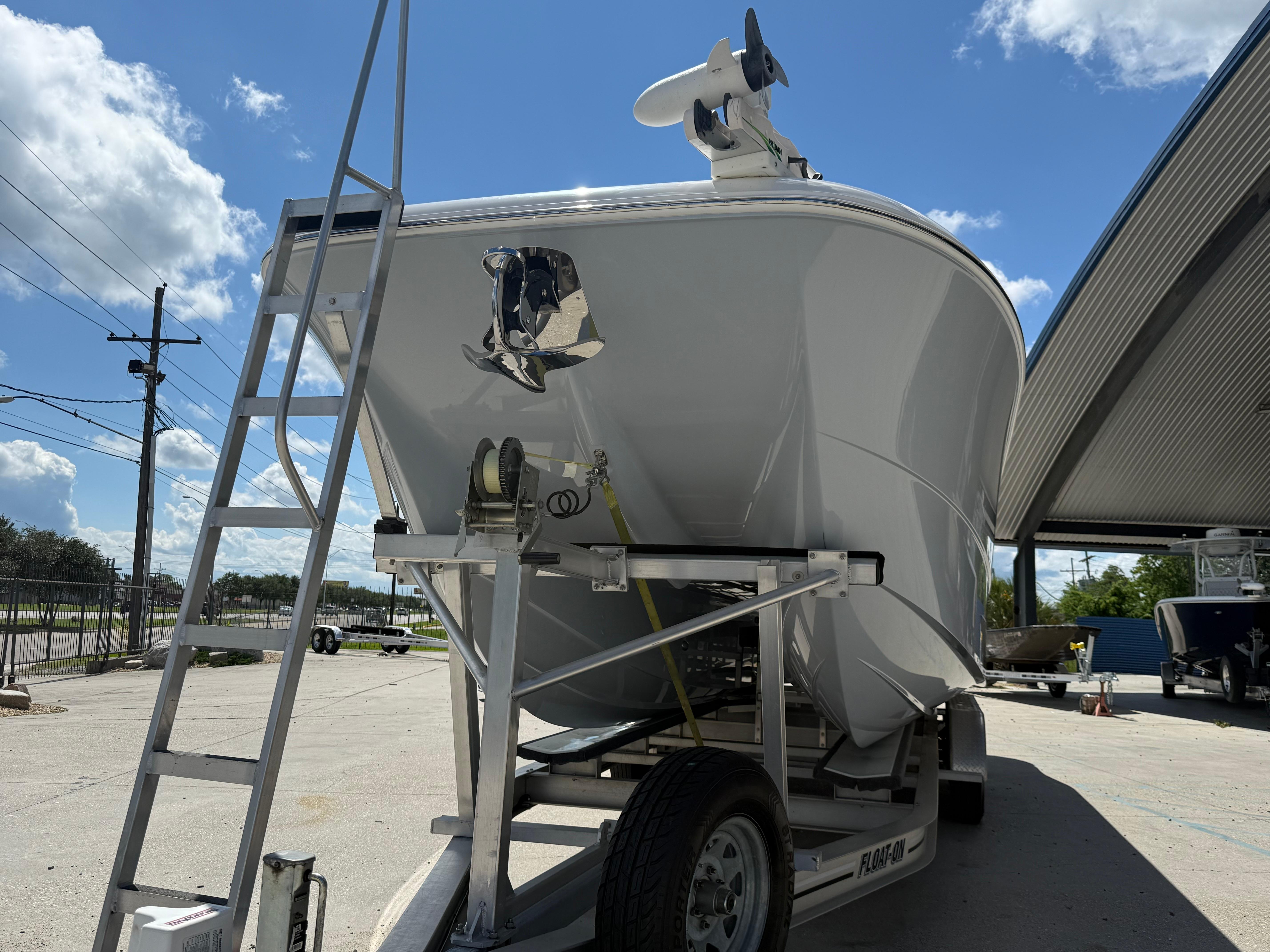 2022 Invincible 33 Catamaran on trailer under clear blue sky.