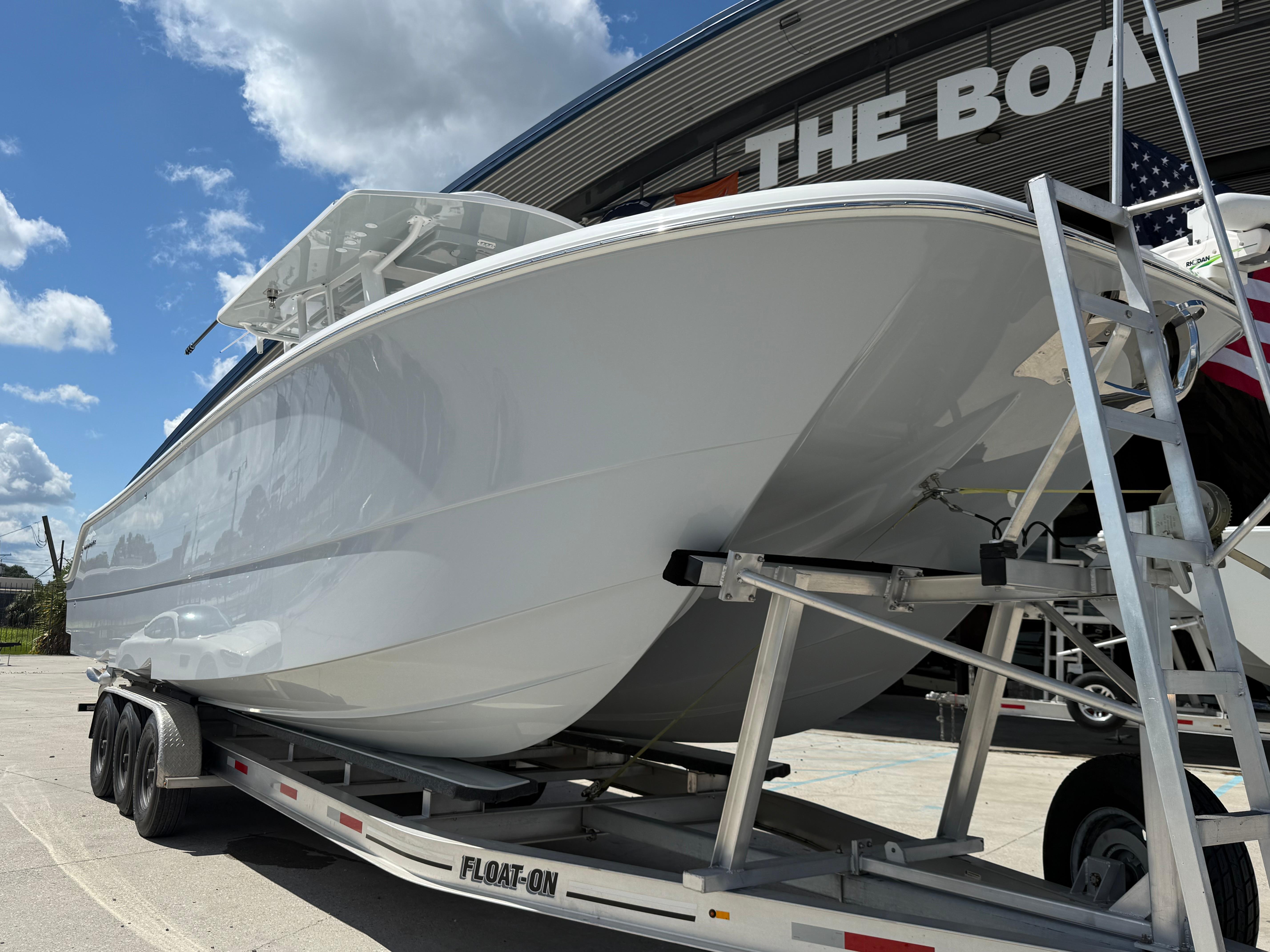 2022 Invincible 33 Catamaran on trailer, displayed outdoors under clear blue sky.