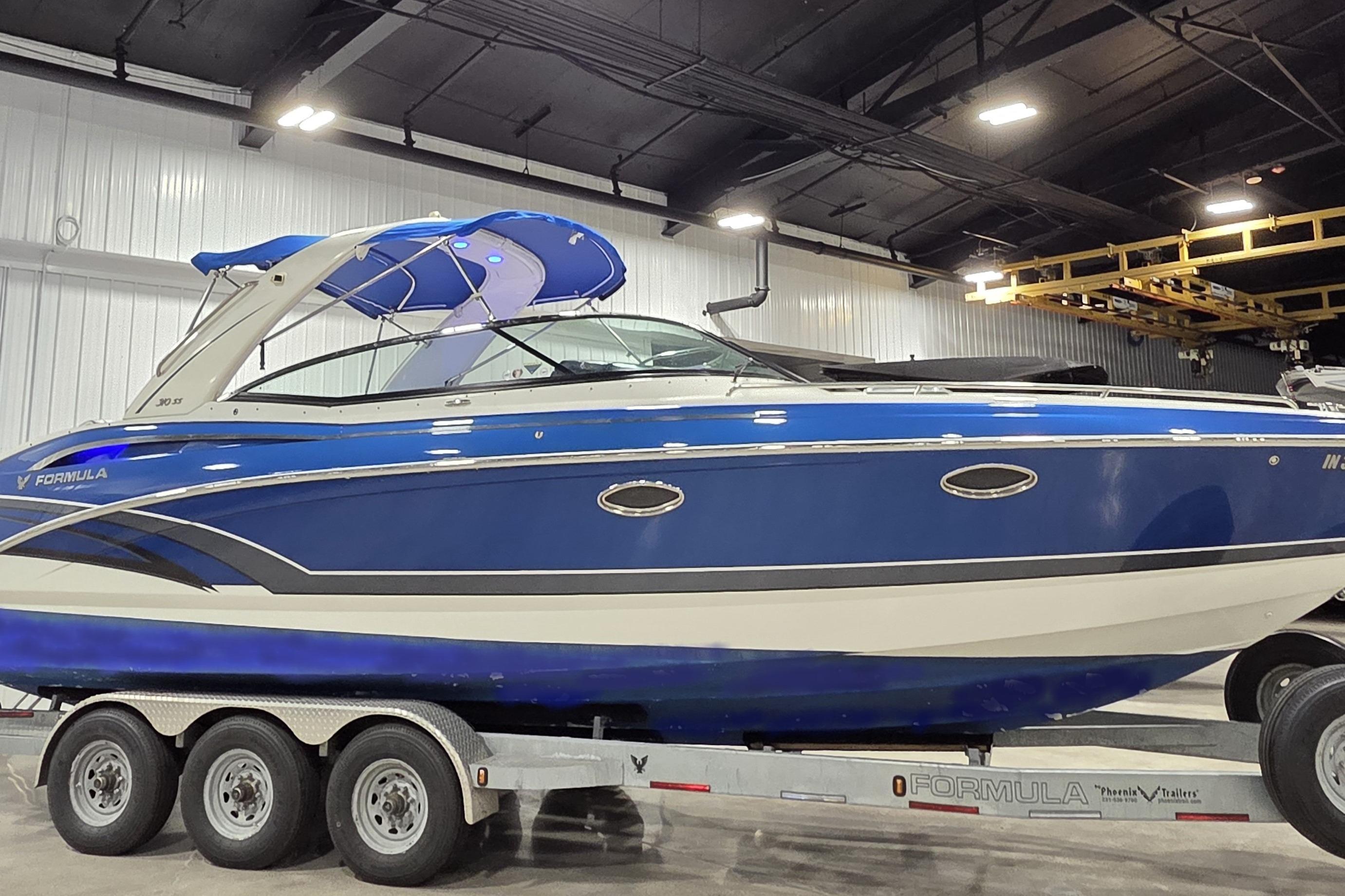 2019 Formula 310 Sun Sport boat on trailer in indoor facility.