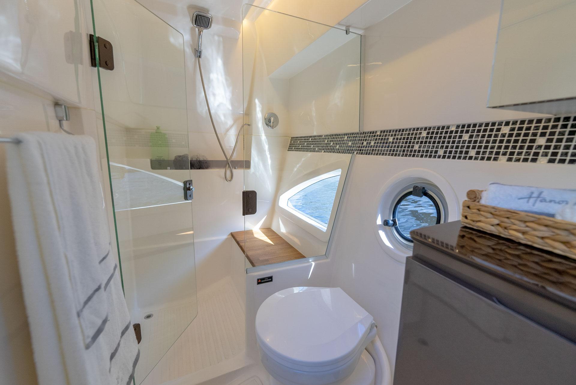 Hanover-415 2024-Music FL-US-Luxurious bathroom in 2024 Hanover 415 yacht with modern shower and porthole view.-9751409 | Thumbnail