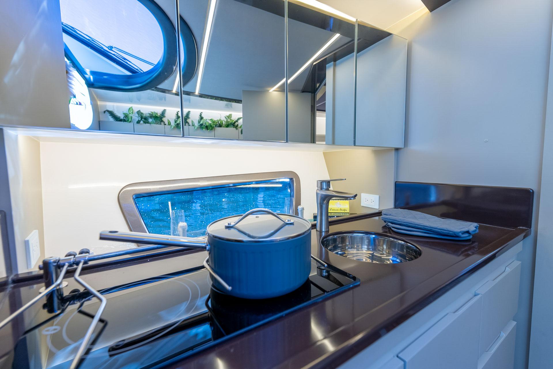 Hanover-415 2024-Music FL-US-Modern kitchen interior on Hanover 415 yacht, featuring sleek design and ocean view, 2024 model.-9751409 | Thumbnail