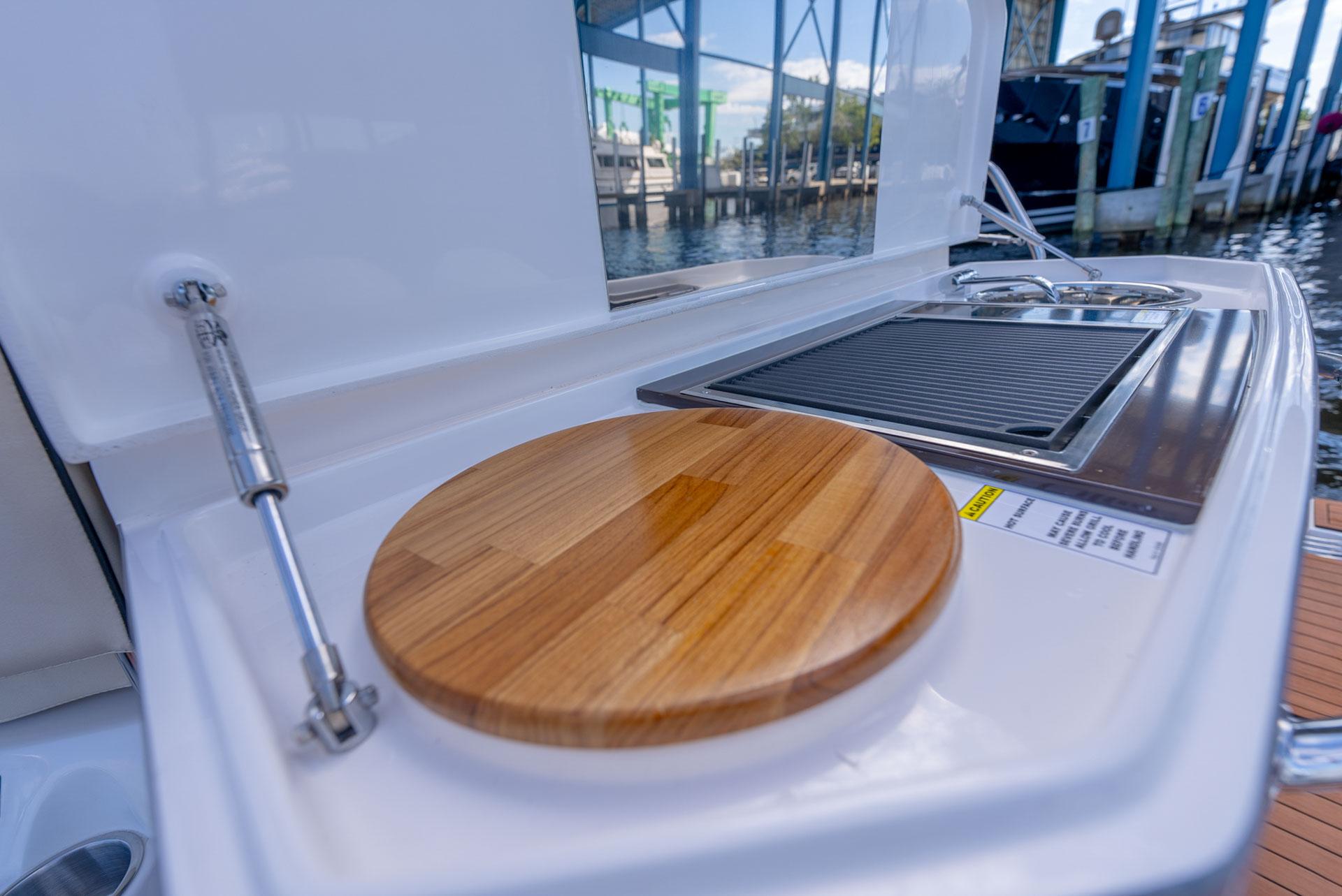 Hanover-415 2024-Music FL-US-Outdoor kitchen on 2024 Hanover 415 yacht with cutting board and grill.-9751409 | Thumbnail