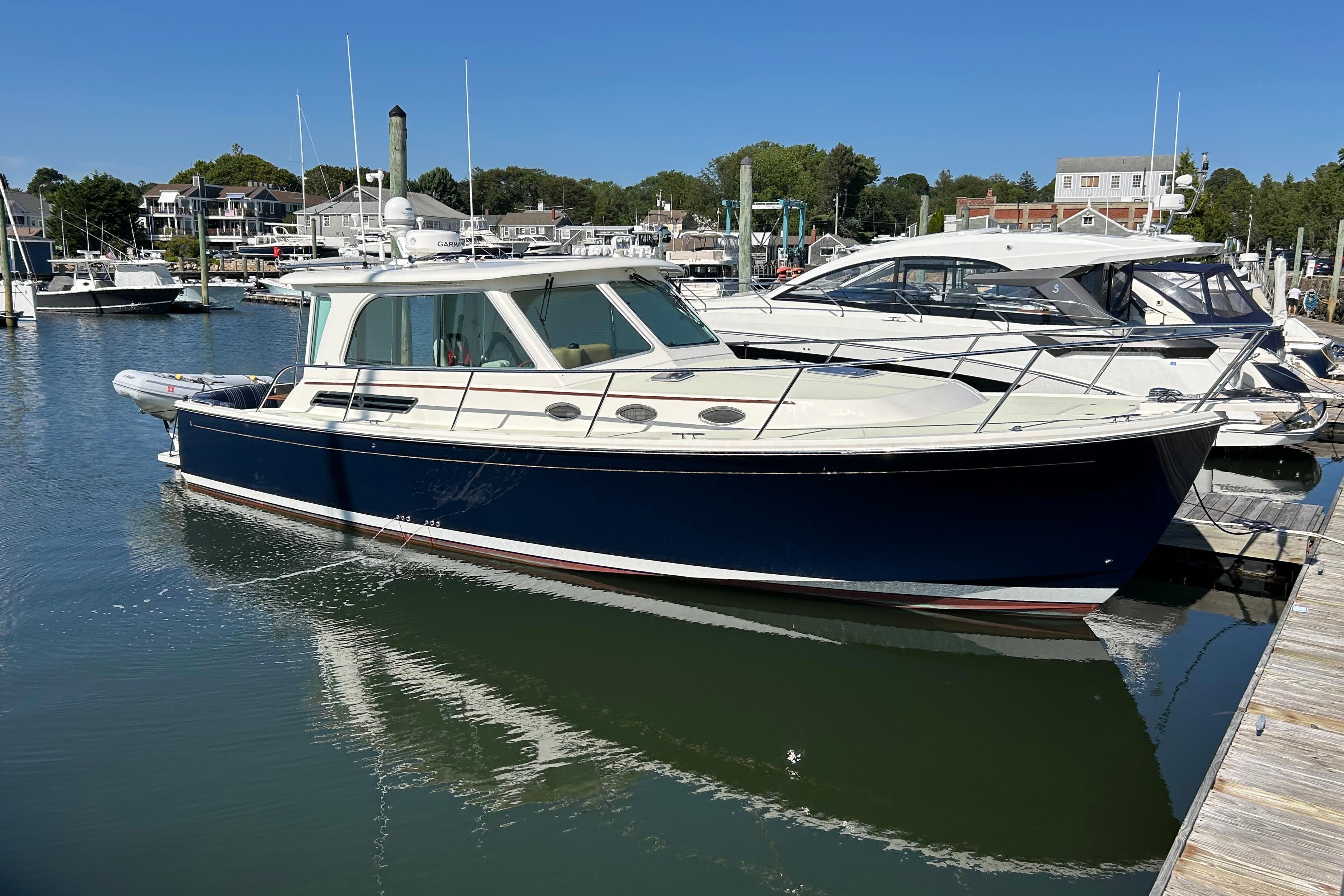 2020 Back Cove 37 yacht docked in a marina under clear blue skies.