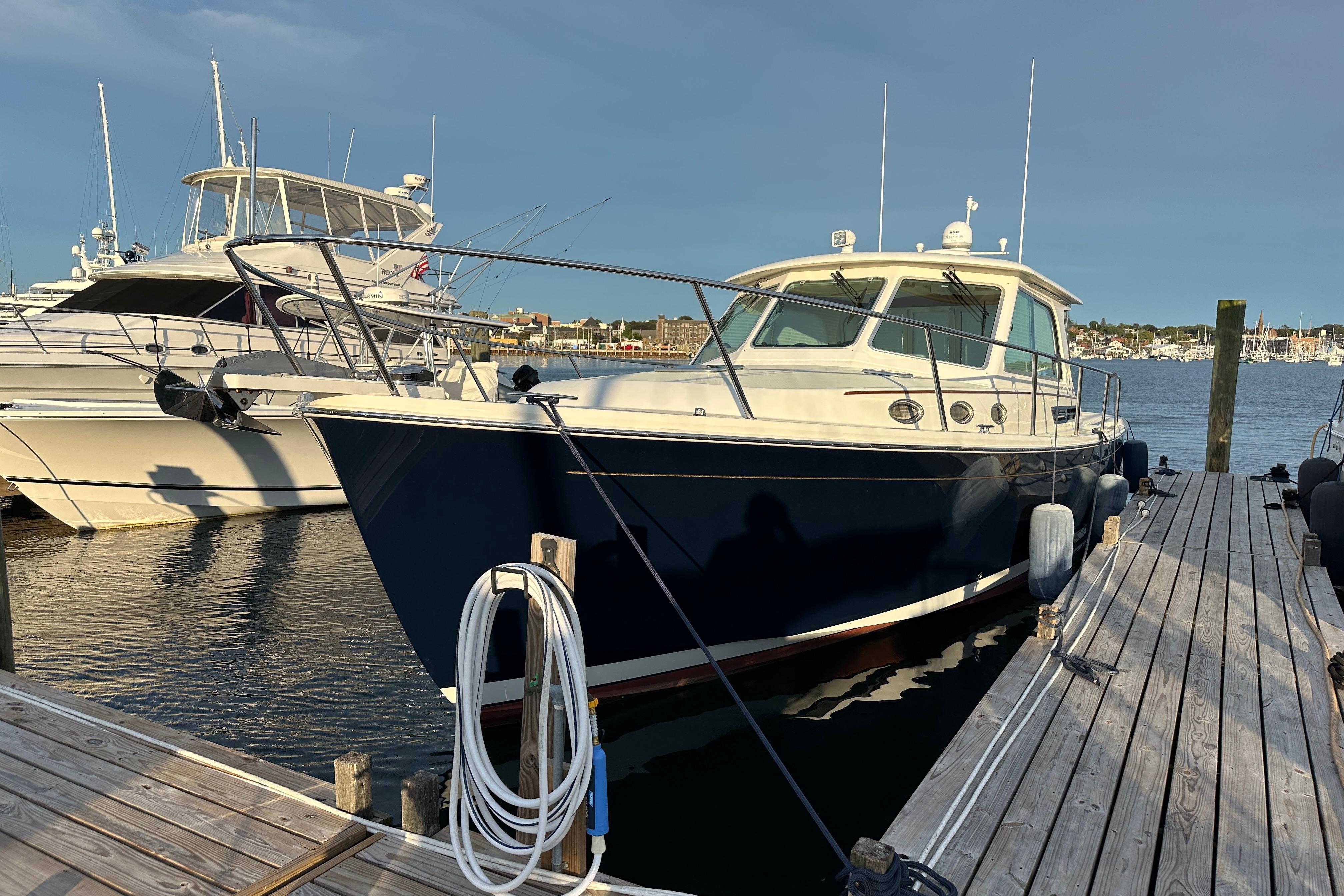 2020 Back Cove 37 yacht docked at marina, sunny day, calm waters.