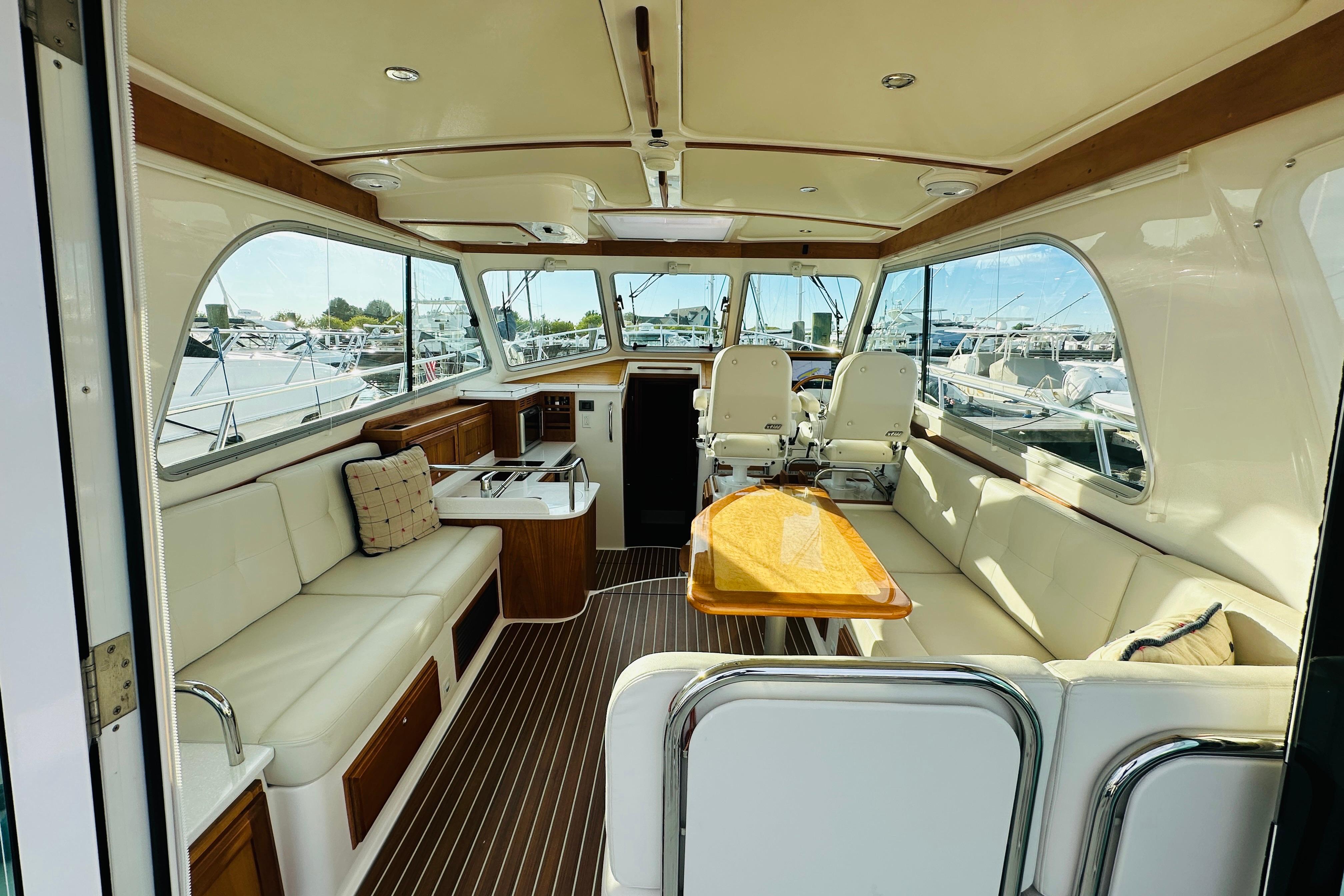 Luxurious interior of 2020 Back Cove 37 yacht with elegant seating and panoramic windows.