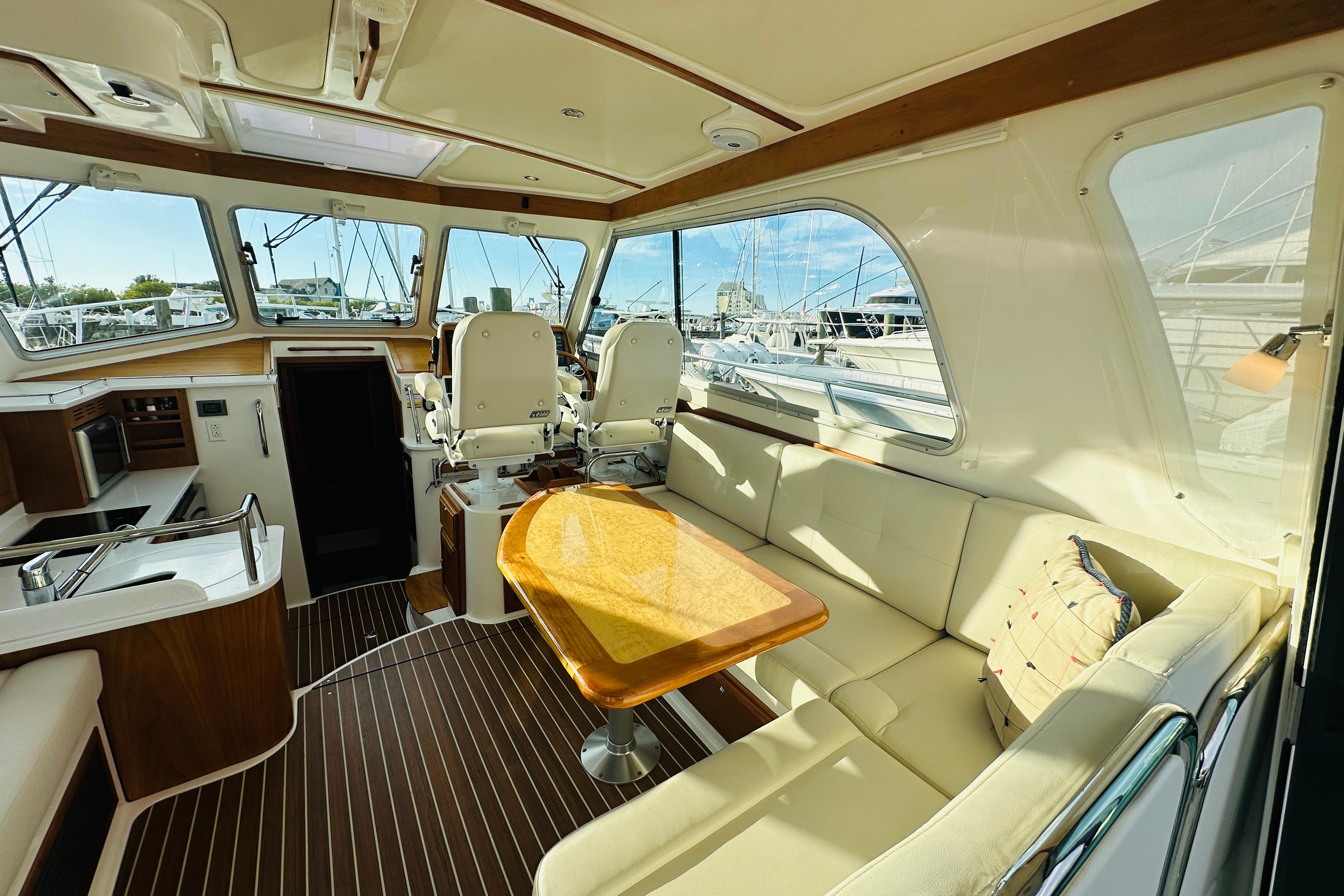 Luxurious interior of 2020 Back Cove 37 yacht with seating and helm station.