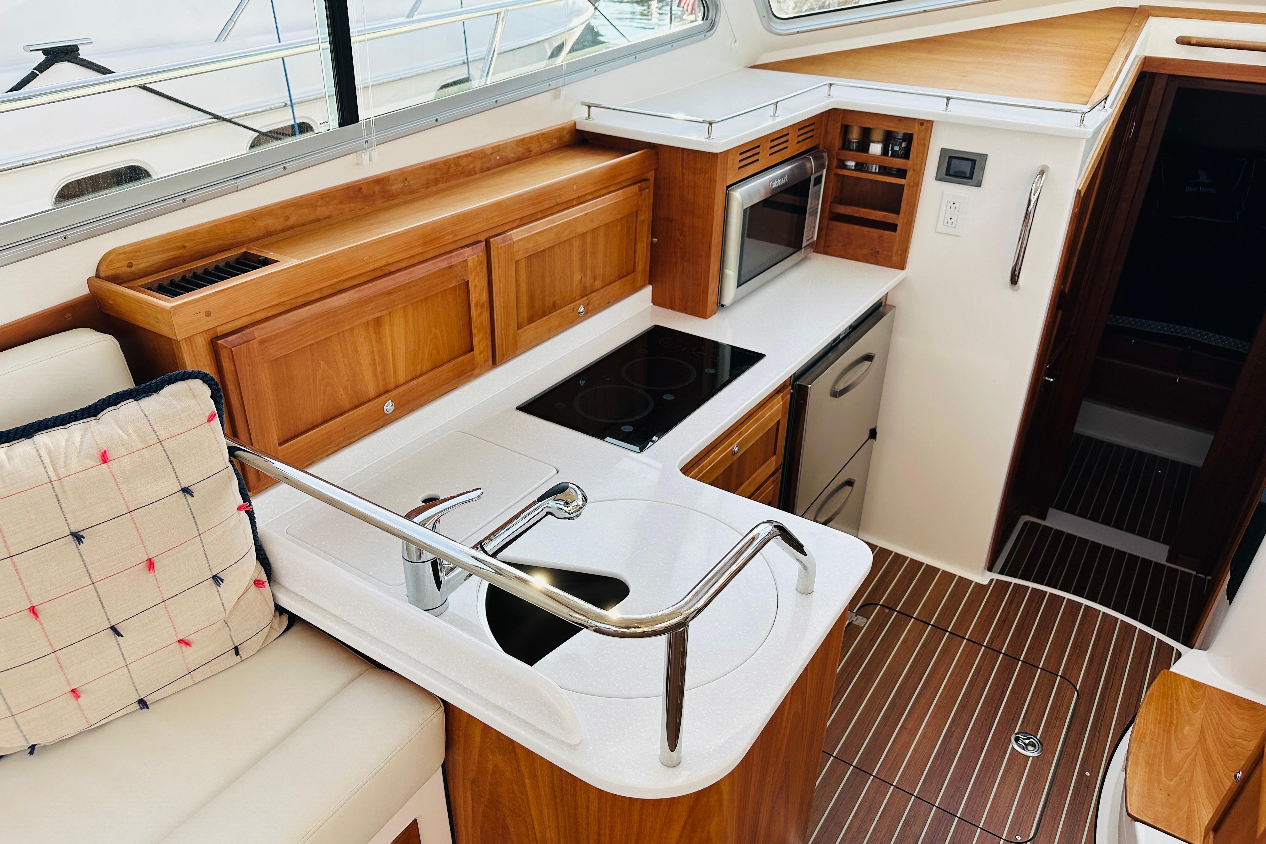 Luxurious 2020 Back Cove 37 yacht interior with modern kitchen and wooden cabinetry.