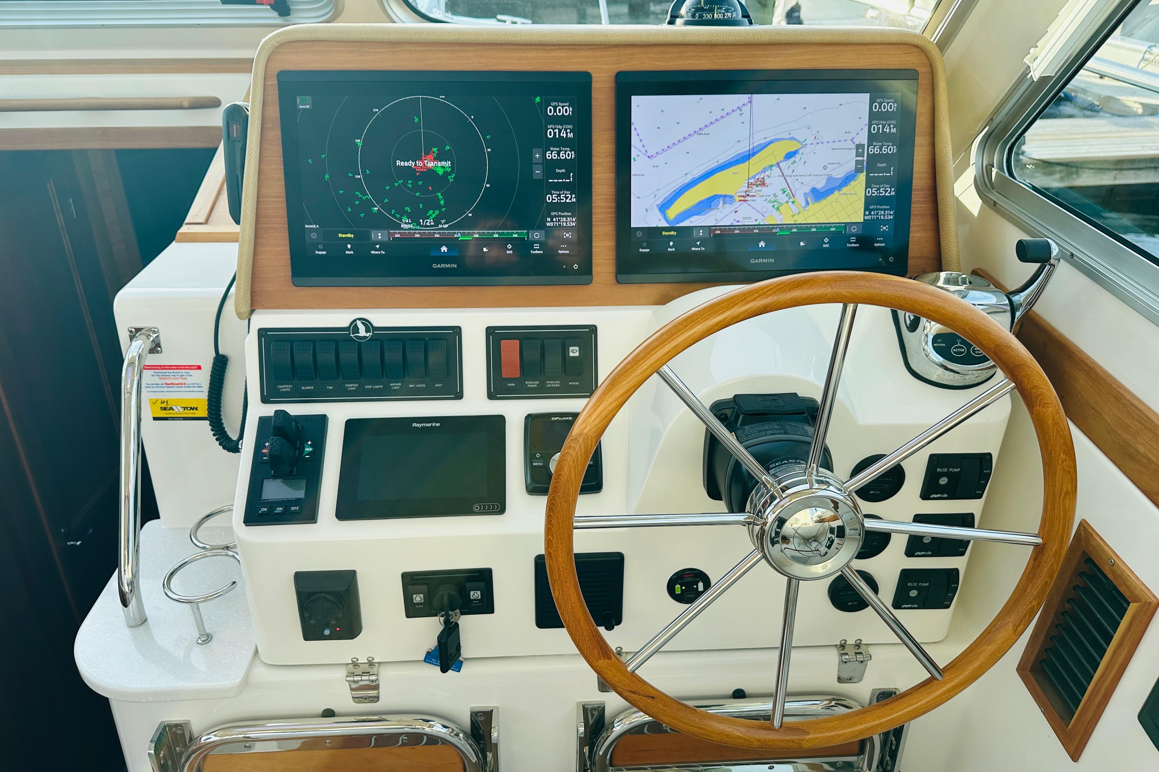 2020 Back Cove 37 helm with dual navigation screens and wooden steering wheel.