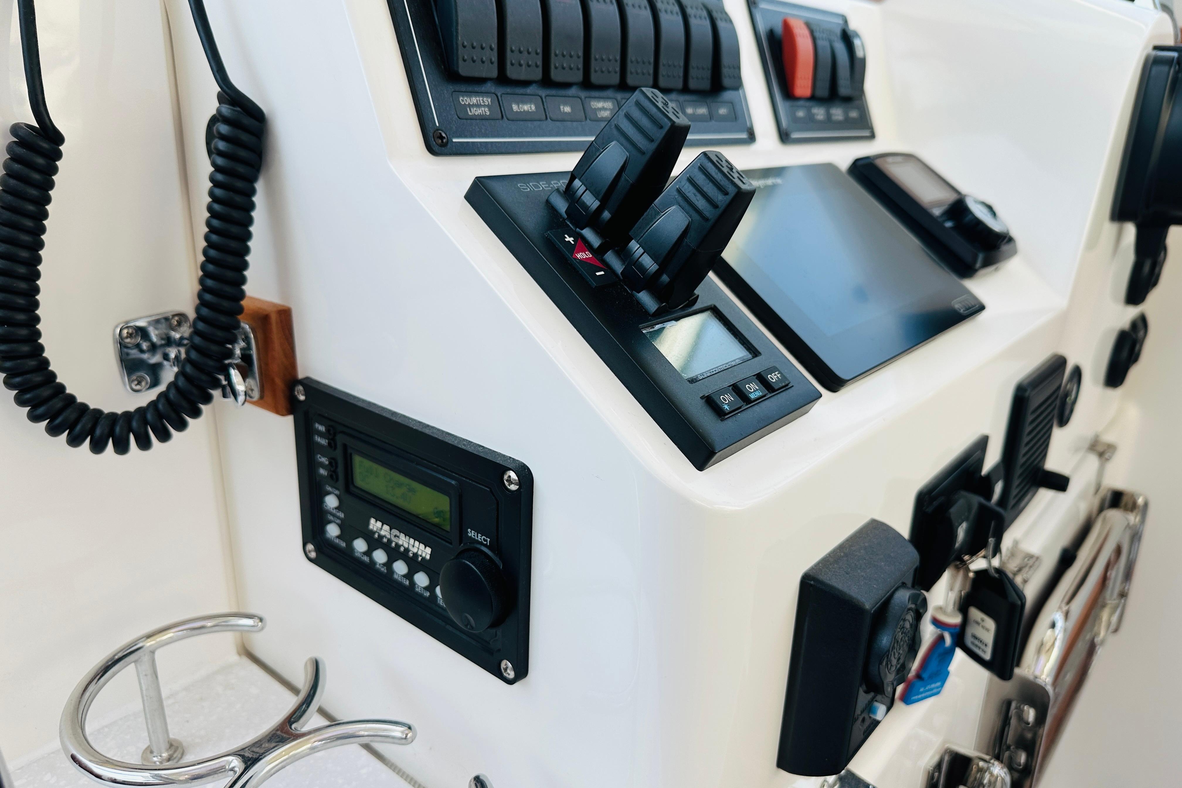Control panel of a 2020 Back Cove 37 boat, featuring switches and communication devices.
