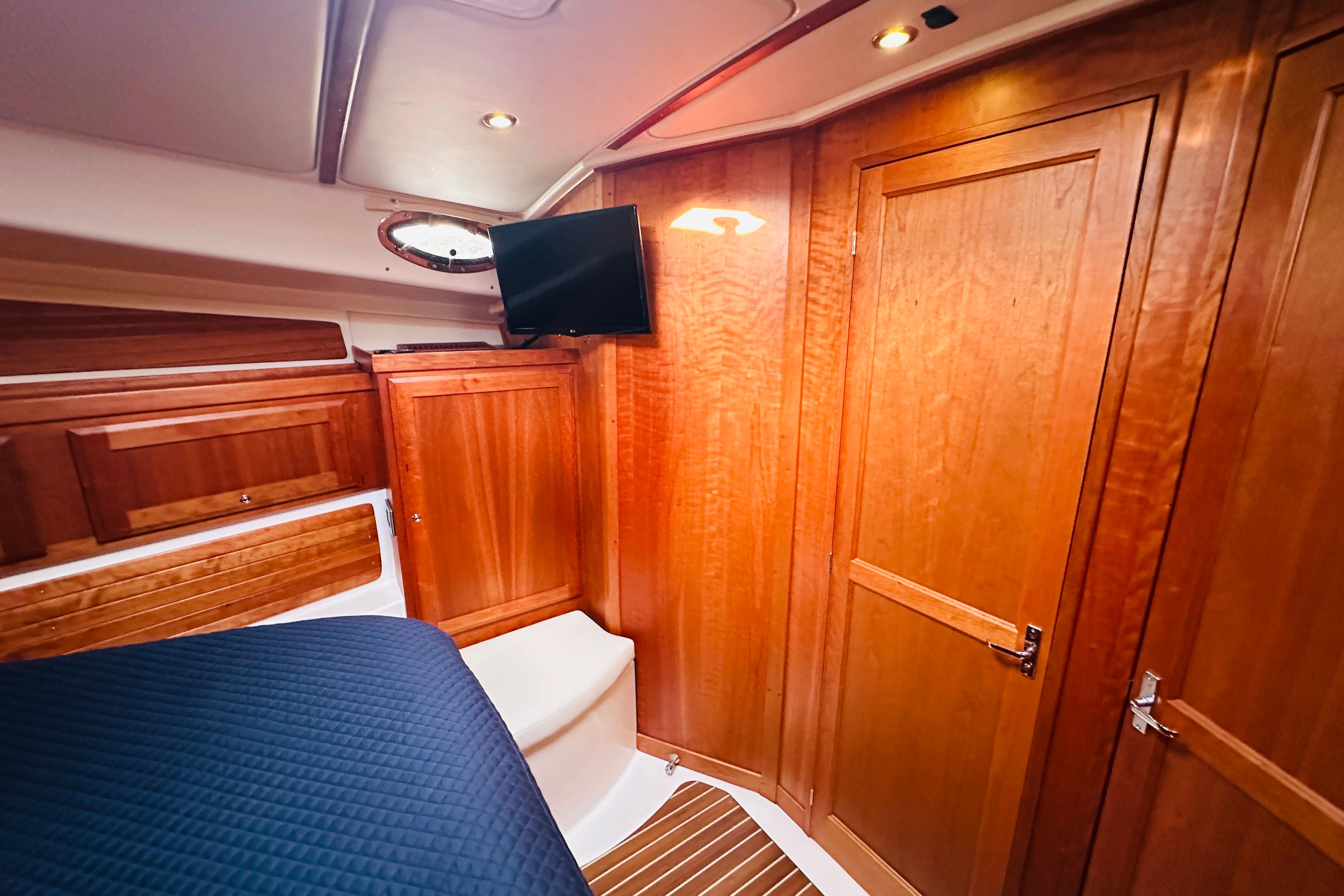 2020 Back Cove 37 yacht interior with wooden cabinetry and mounted TV.
