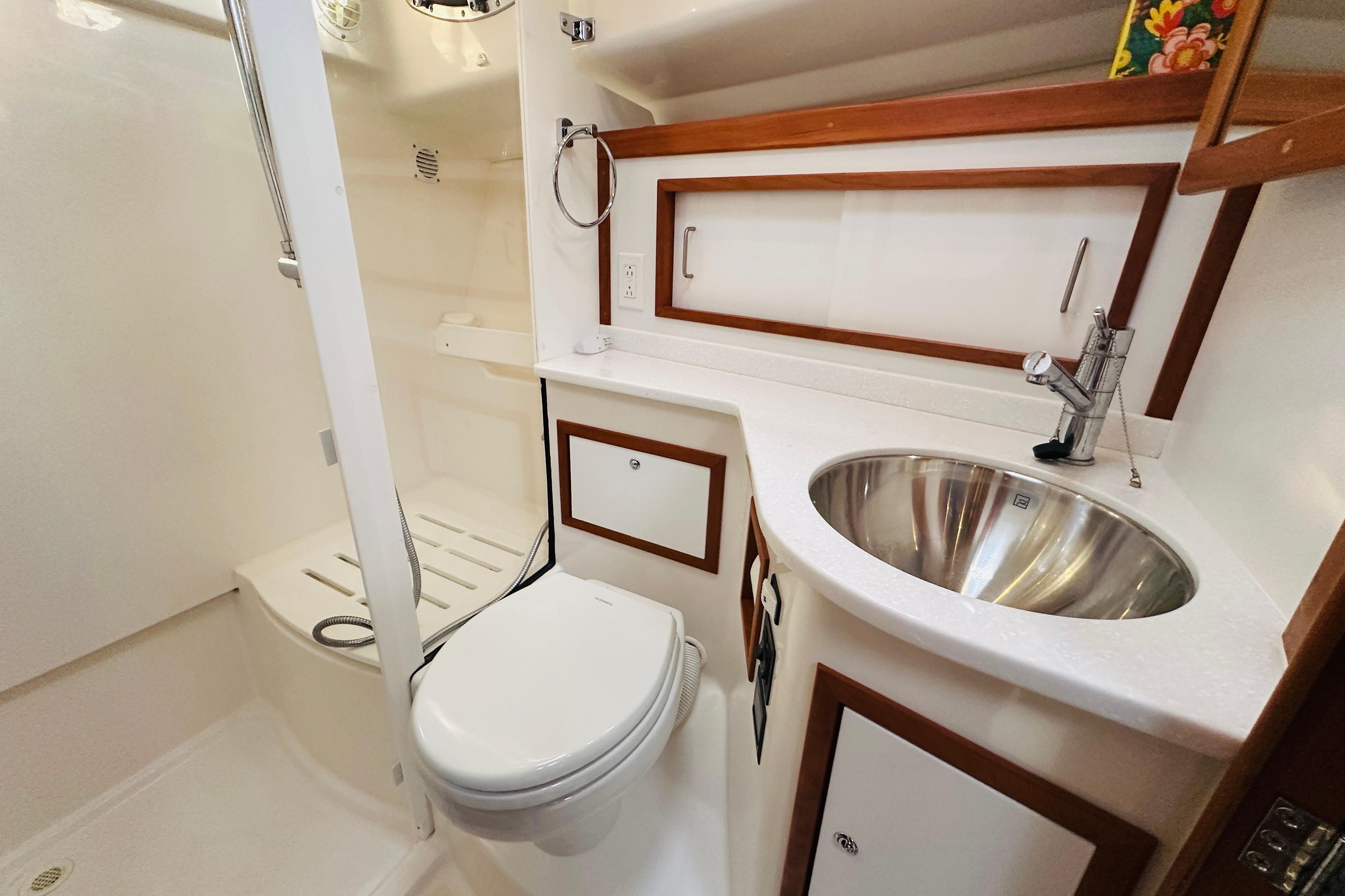Modern bathroom in a 2020 Back Cove 37 yacht, featuring a sleek sink and shower.