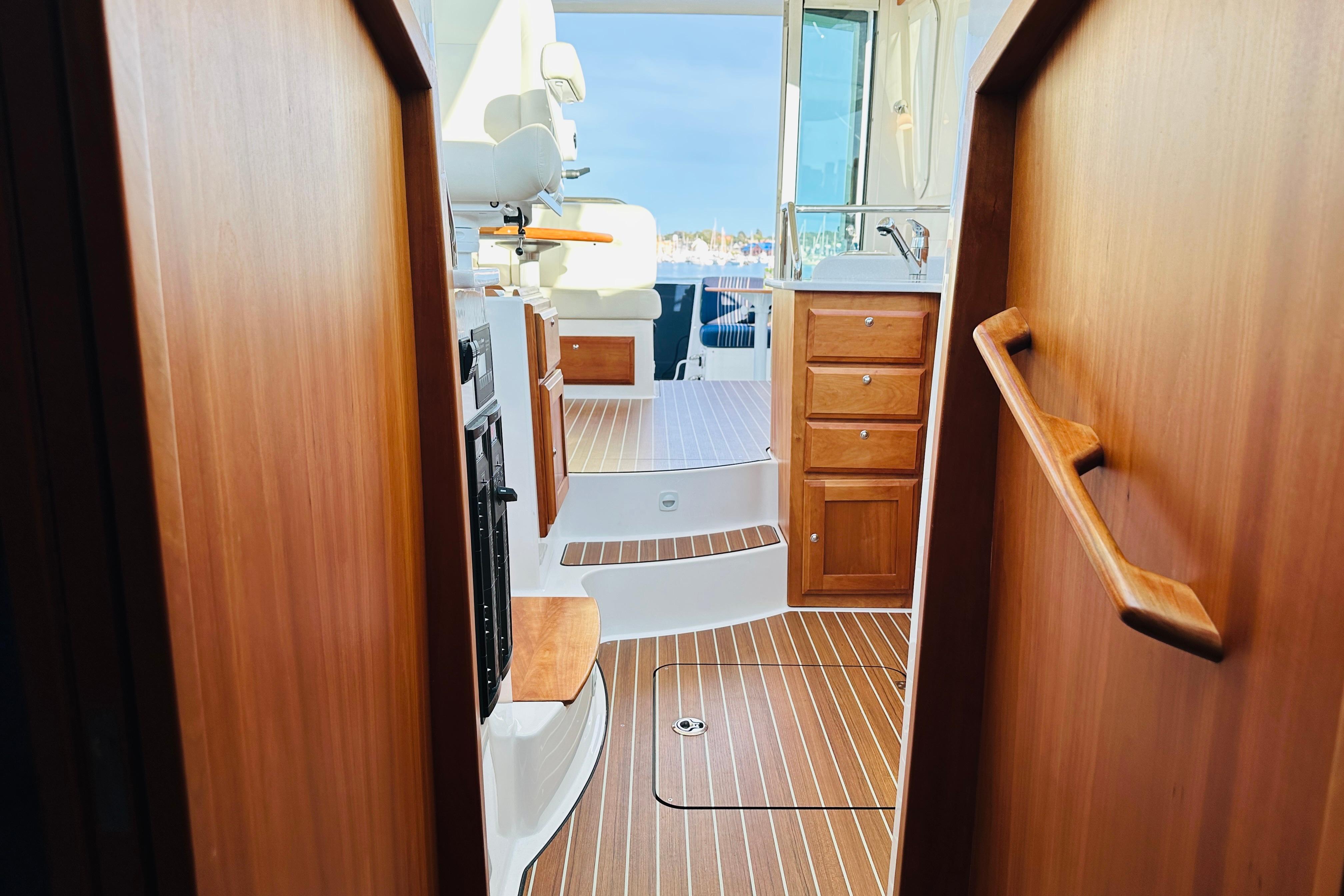 Interior view of 2020 Back Cove 37 yacht, featuring wooden cabinetry and seating.