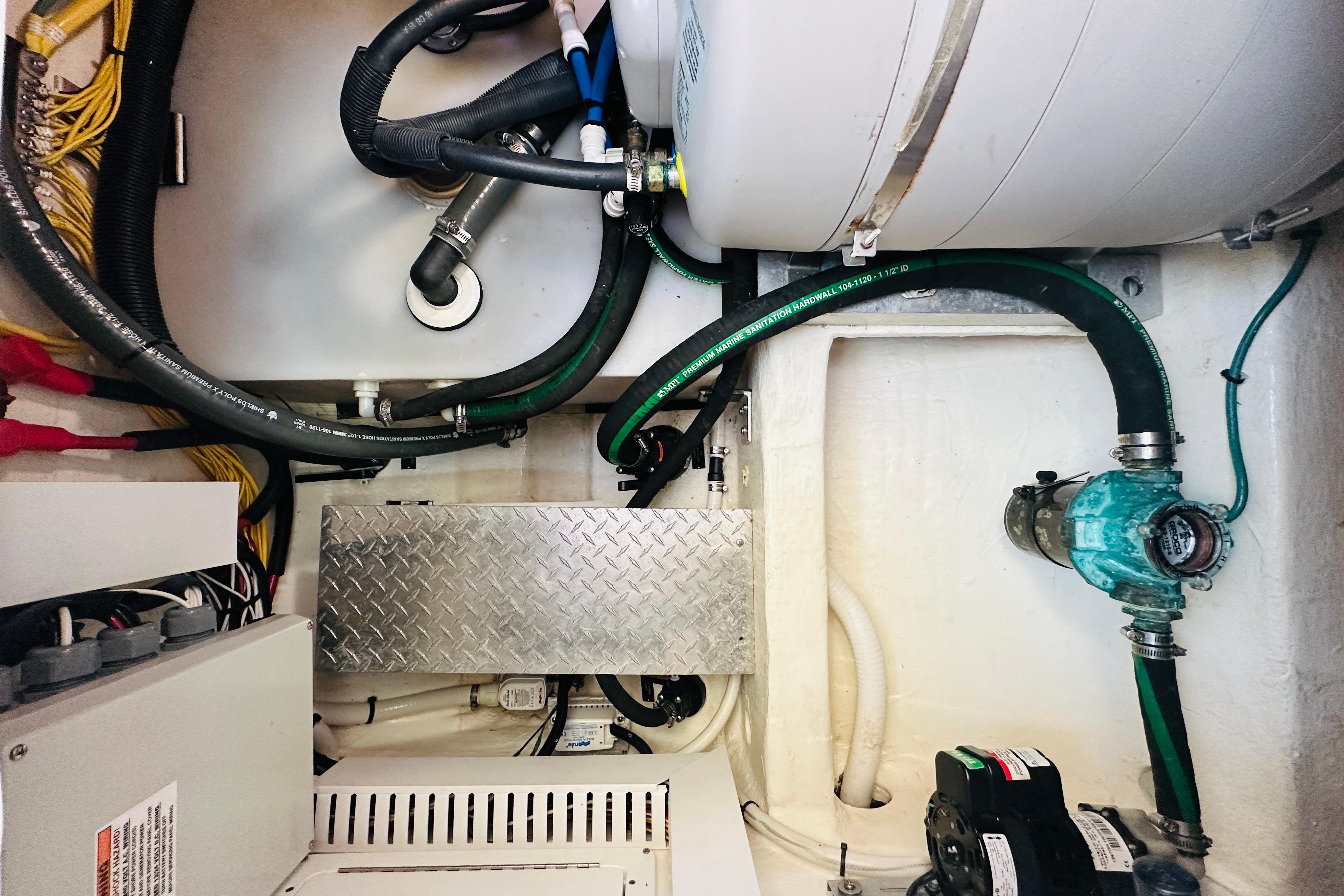 Engine room of 2020 Back Cove 37 boat with visible hoses and machinery.