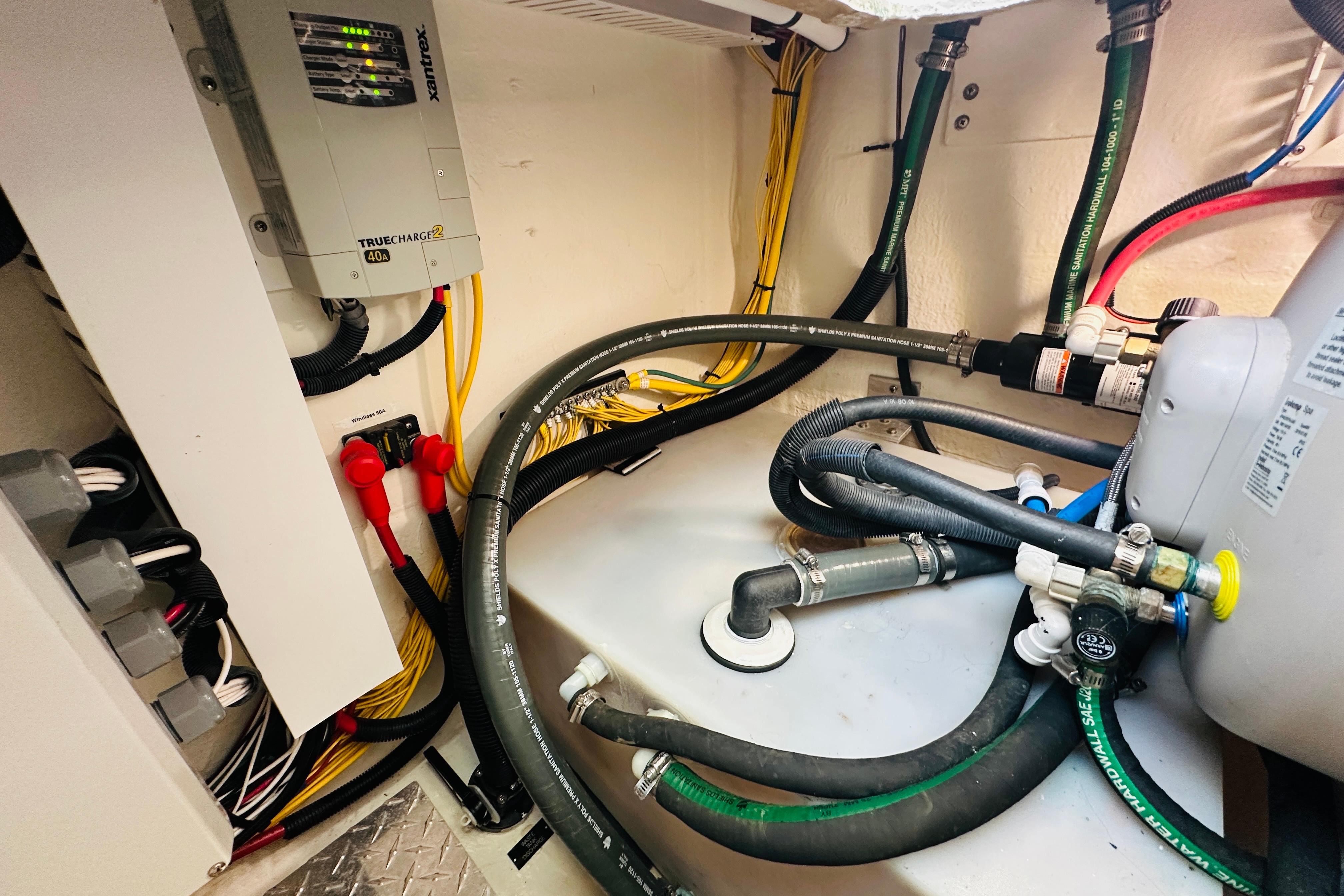 Engine room of 2020 Back Cove 37 boat with wiring and plumbing systems.