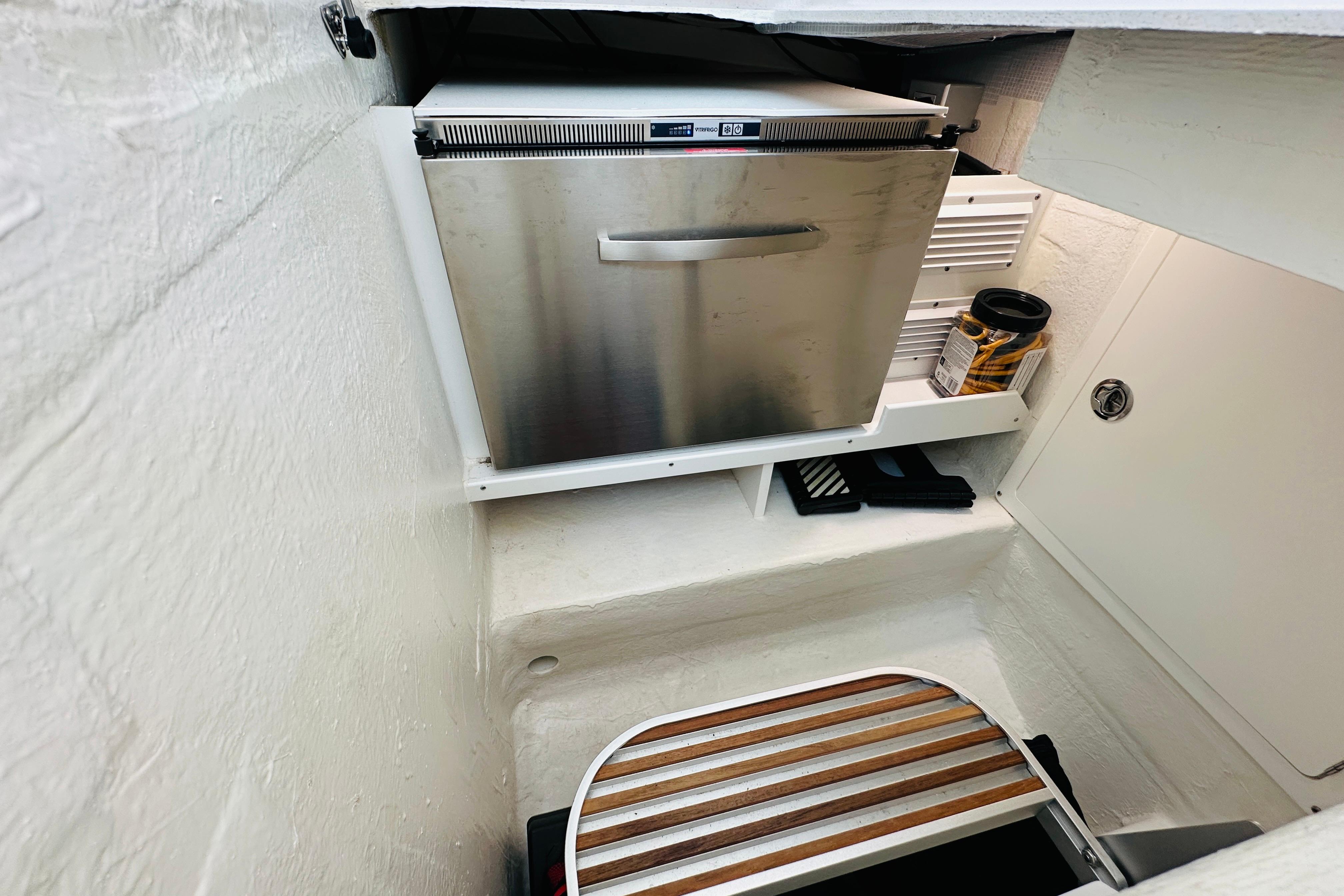 2020 Back Cove 37 boat interior with stainless steel fridge and storage area.