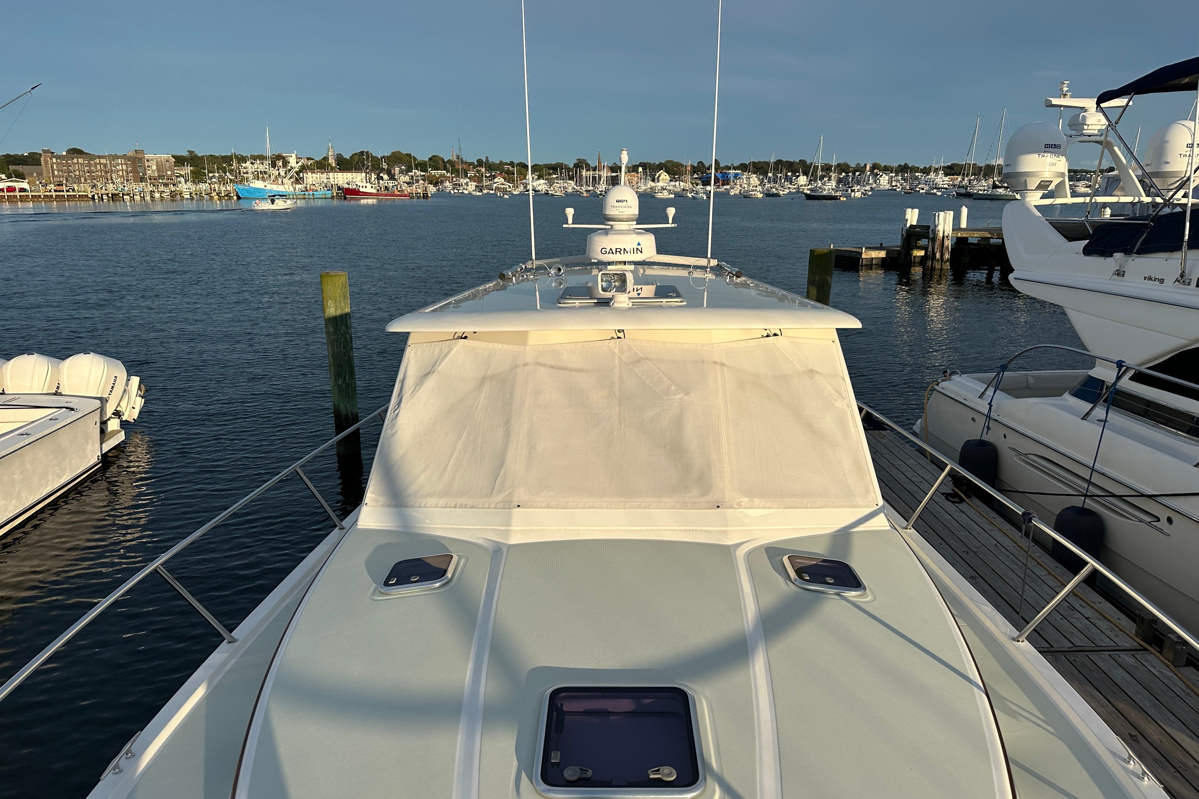 2020 Back Cove 37 yacht docked in a marina, surrounded by calm waters and other boats.