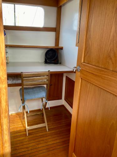 1977 Grand Alaskan Raised Pilothouse interior with wooden desk and chair.