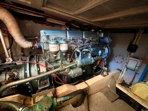 Engine room of 1977 Grand Alaskan Raised Pilothouse, showcasing detailed machinery and components.