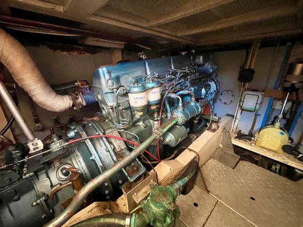 Engine room of 1977 Grand Alaskan Raised Pilothouse yacht, showcasing detailed machinery.