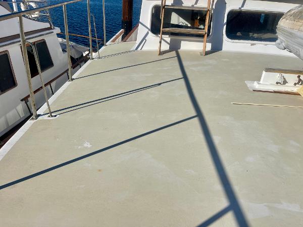 1977 Grand Alaskan Raised Pilothouse deck with railing and ocean view.