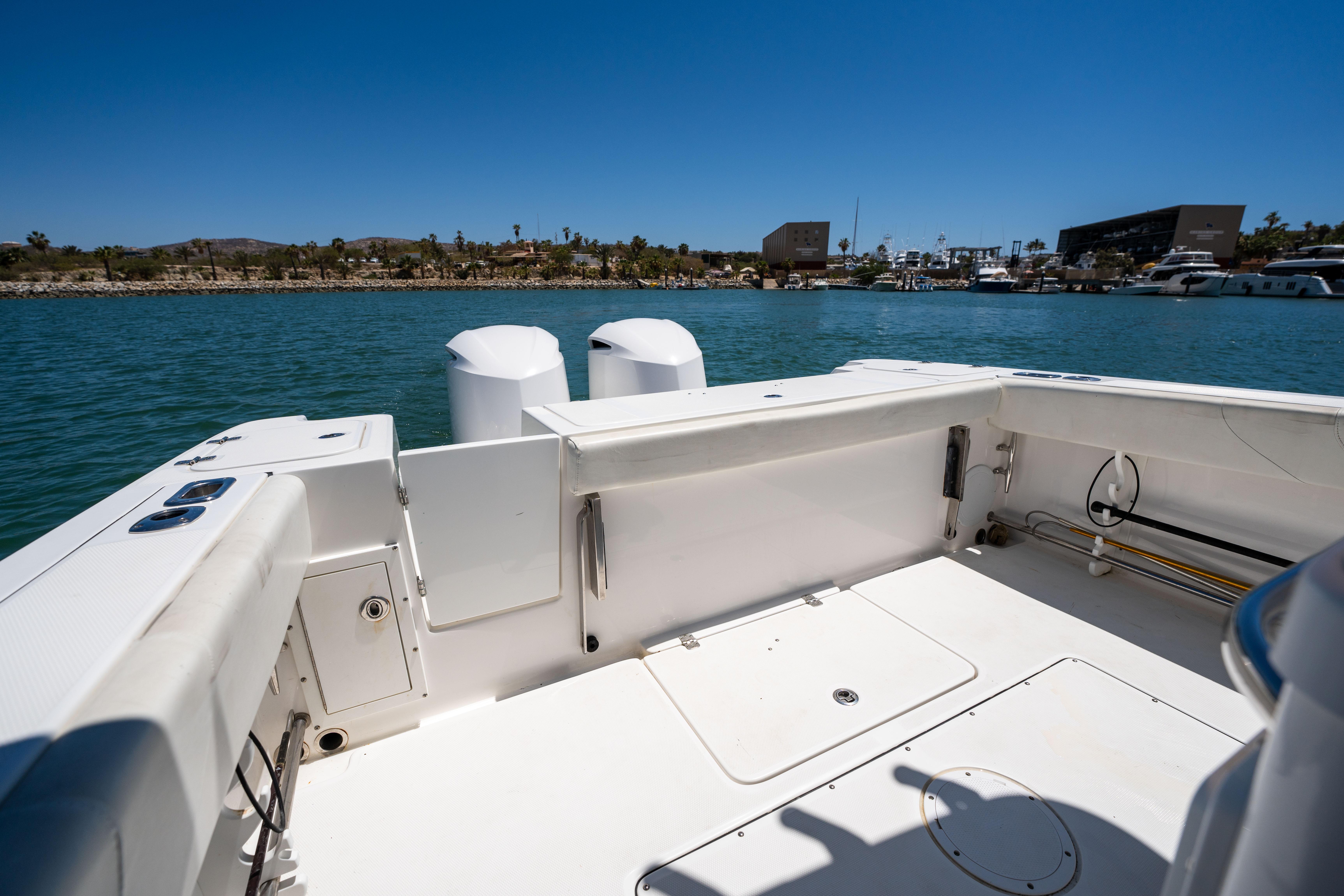 Edgewater-320CC 2020-Carnal CA-US-Edgewater 320CC 2020 boat deck with dual engines, on calm water under clear blue sky.-9821525 | Thumbnail