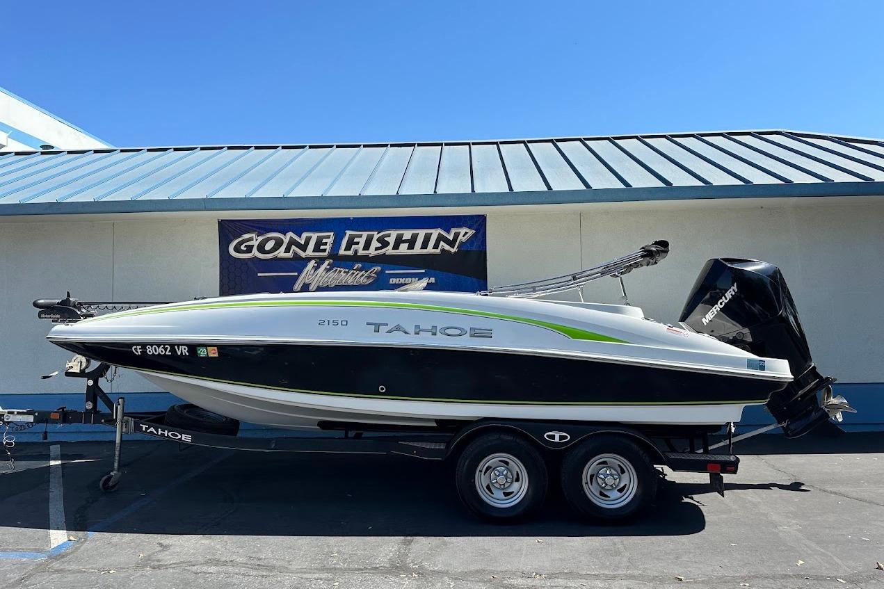 2019 Tahoe 2150 boat on trailer, parked outside 