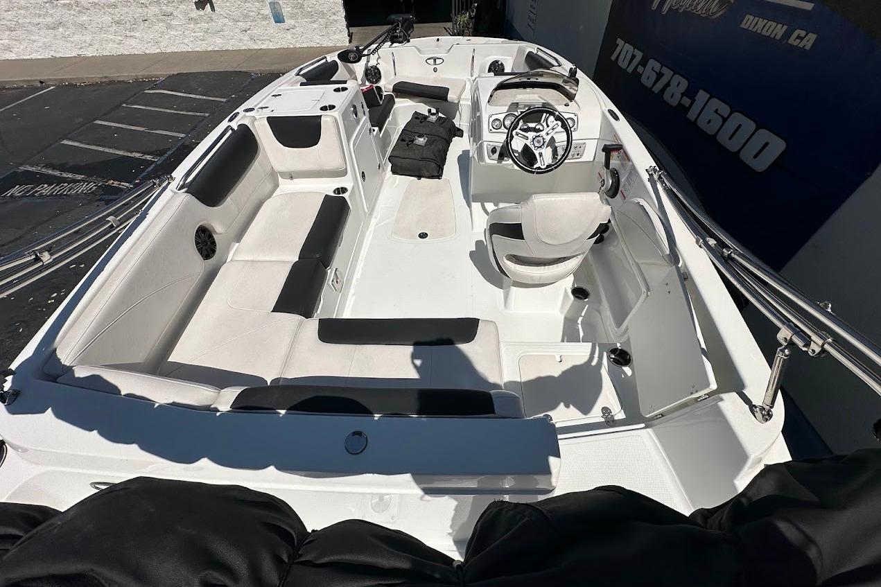 2019 Tahoe 2150 boat interior with seating, steering wheel, and controls.