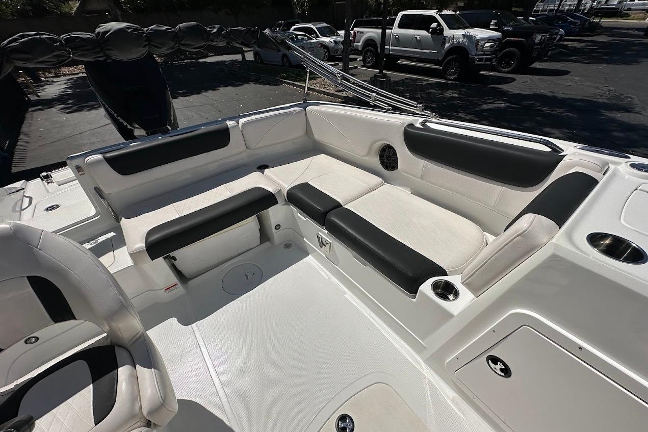 2019 Tahoe 2150 boat interior with white and black seating, cup holders, and storage compartments.