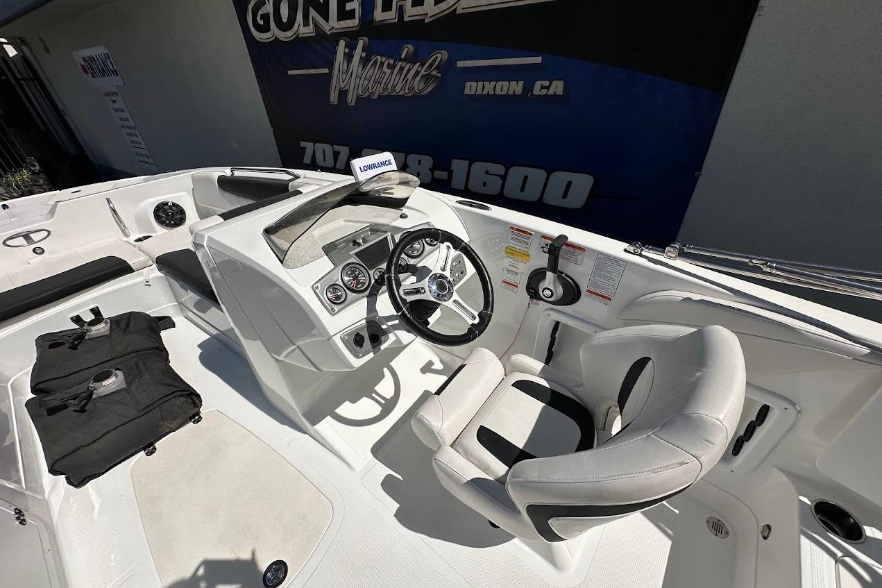 2019 Tahoe 2150 boat interior with steering wheel, gauges, and seating.