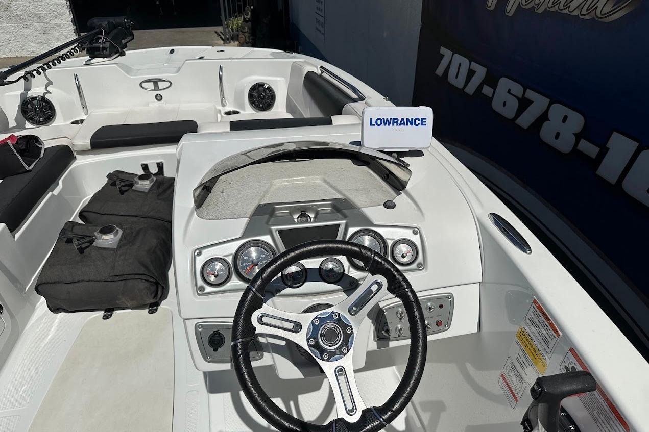 2019 Tahoe 2150 boat interior with steering wheel and Lowrance navigation system.