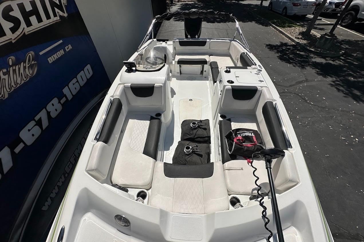 2019 Tahoe 2150 boat interior with seating and equipment, parked outdoors.