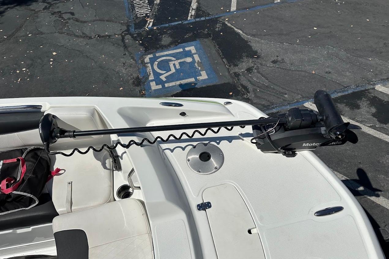 2019 Tahoe 2150 boat with trolling motor in parking lot.