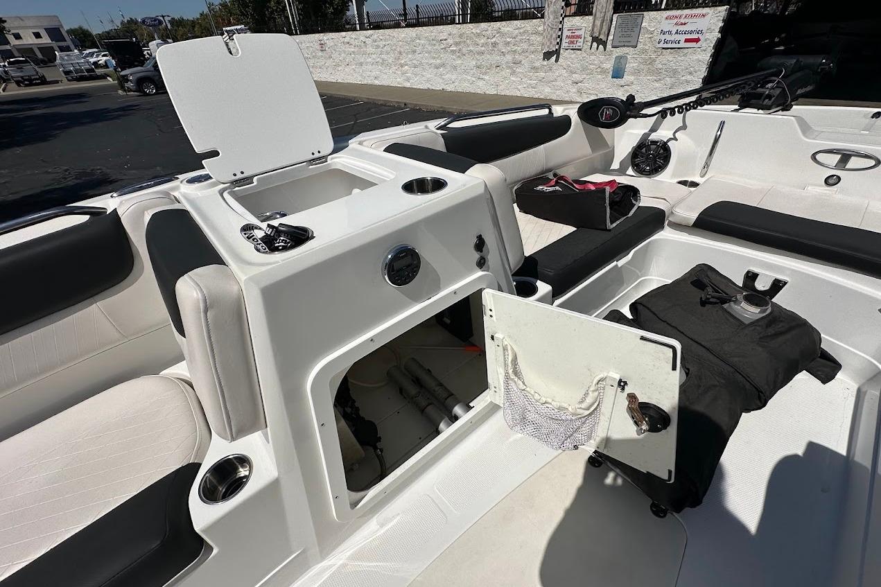 2019 Tahoe 2150 boat interior with open storage compartments and seating.