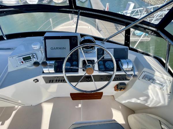 Cockpit of 1997 Sabre Motor Yacht with Garmin navigation system and steering wheel.