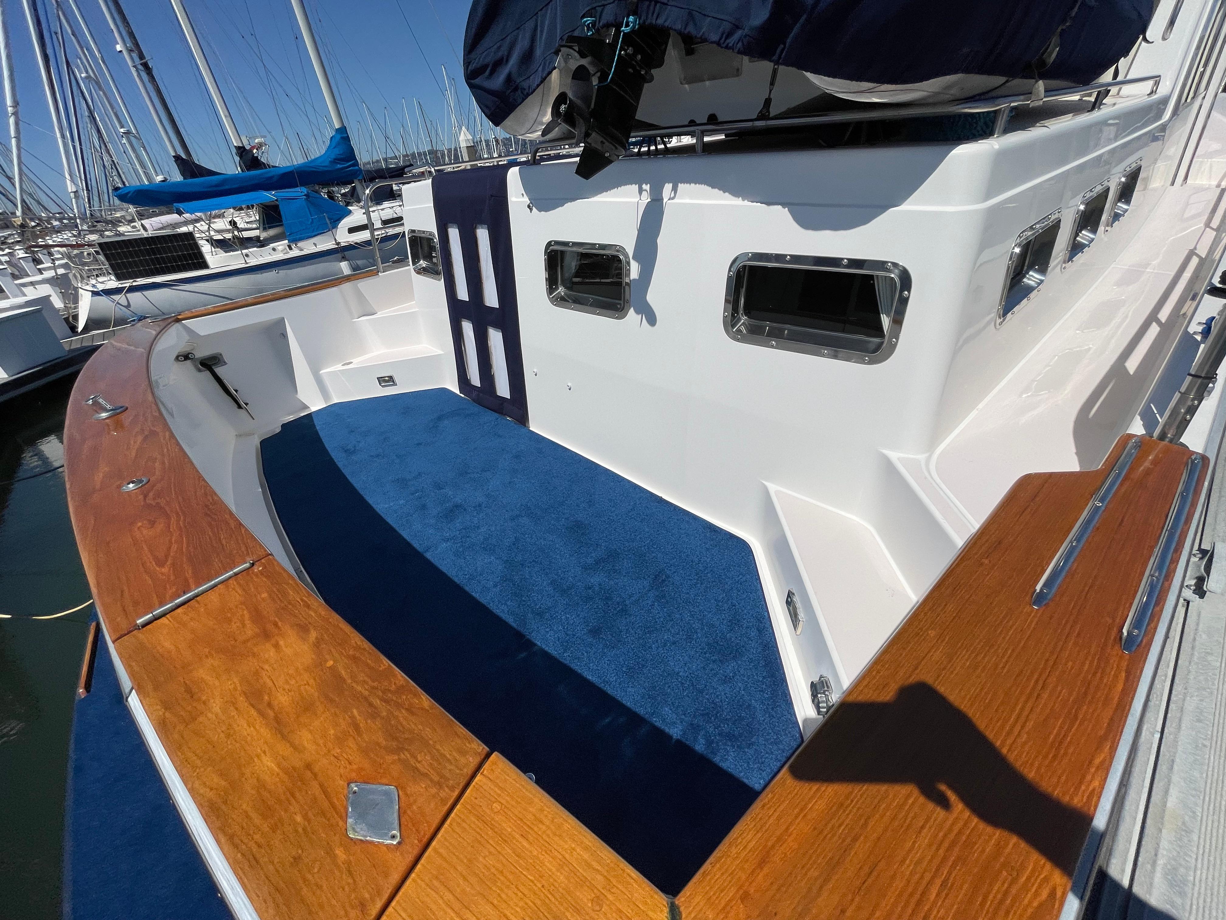 1997 Sabre Cockpit Motor Yacht with blue carpet and wooden railings in marina setting.