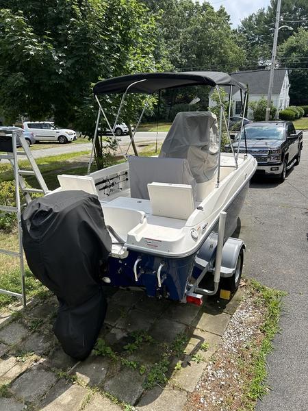 2017 Bayliner Element F18 CC boat on trailer, parked in driveway.