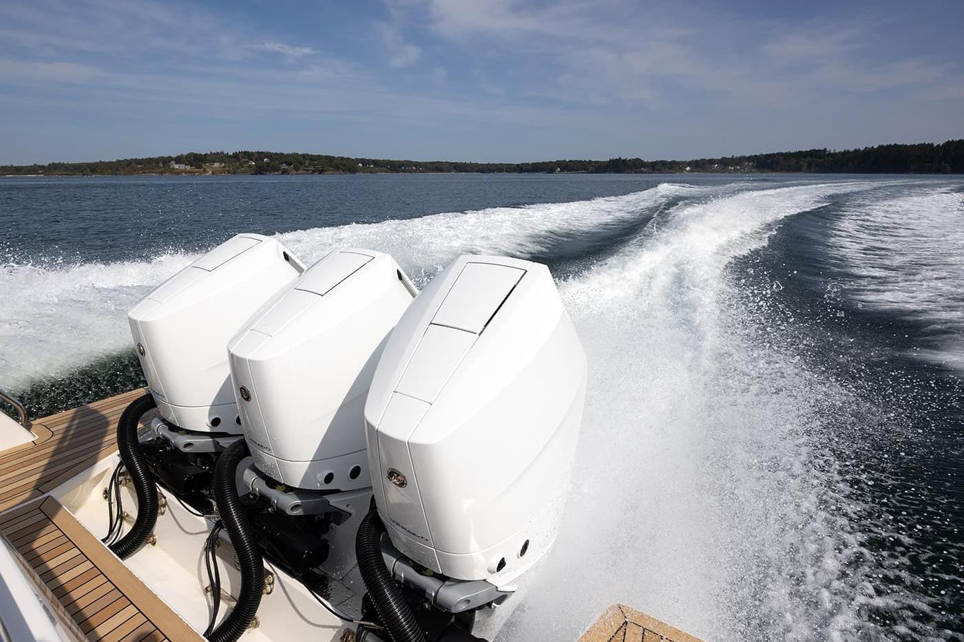 2027 Back Cove 39O boat with triple outboard engines cruising on open water.