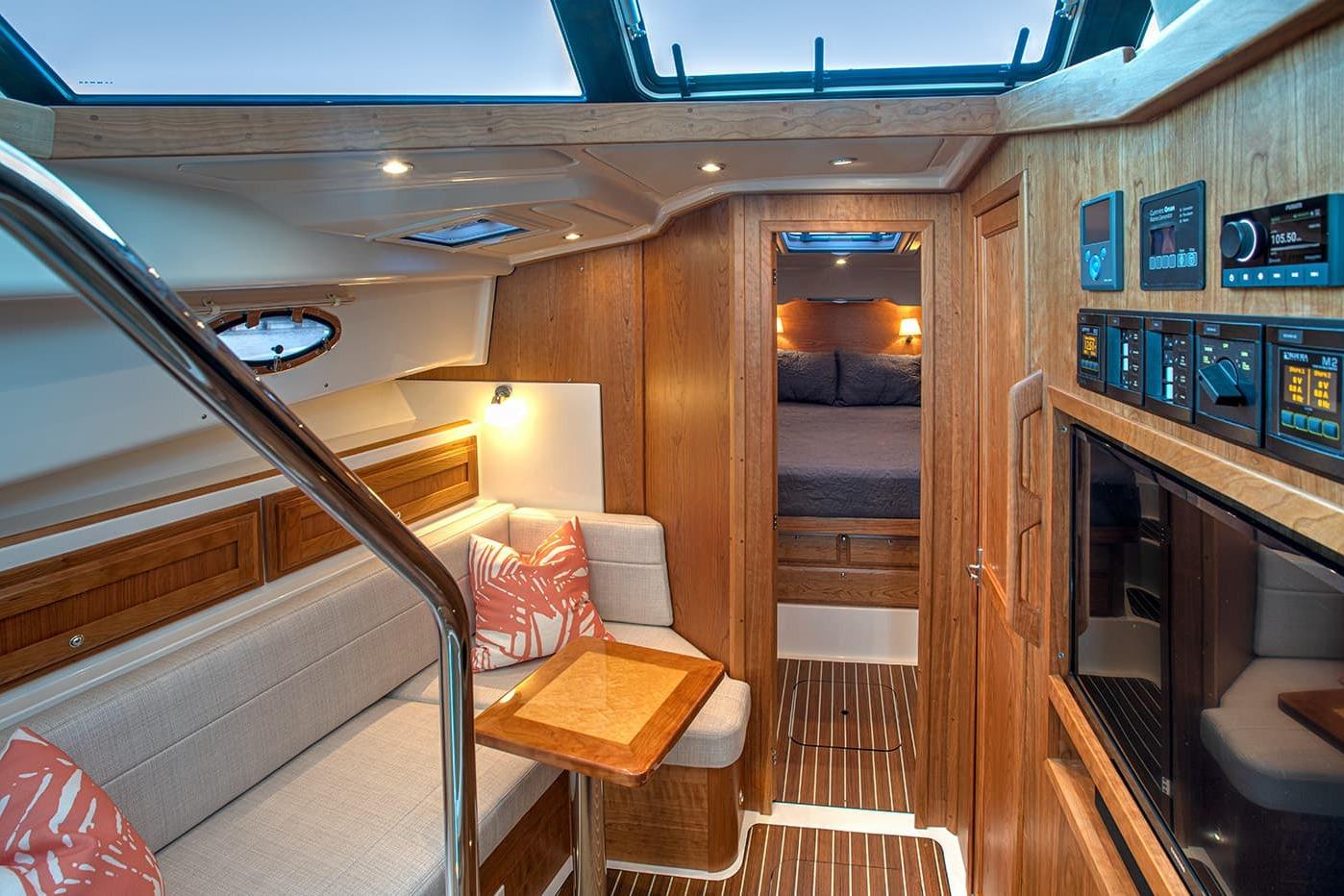 Luxurious interior of 2027 Back Cove 39O yacht with wood finishes and modern amenities.