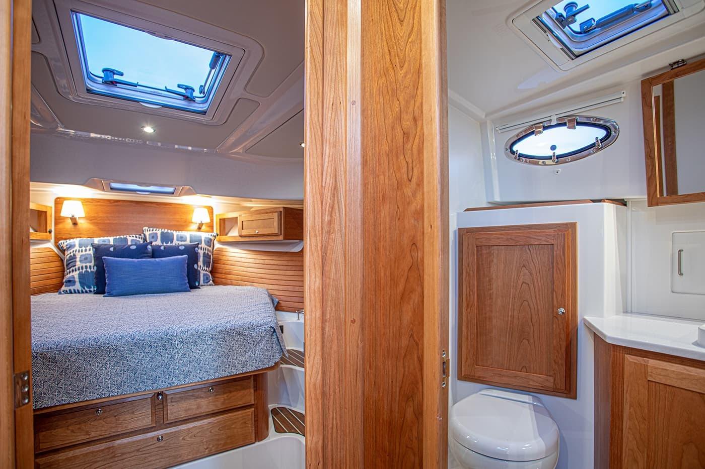 Luxurious cabin interior of 2027 Back Cove 39O yacht with cozy bed and modern bathroom.