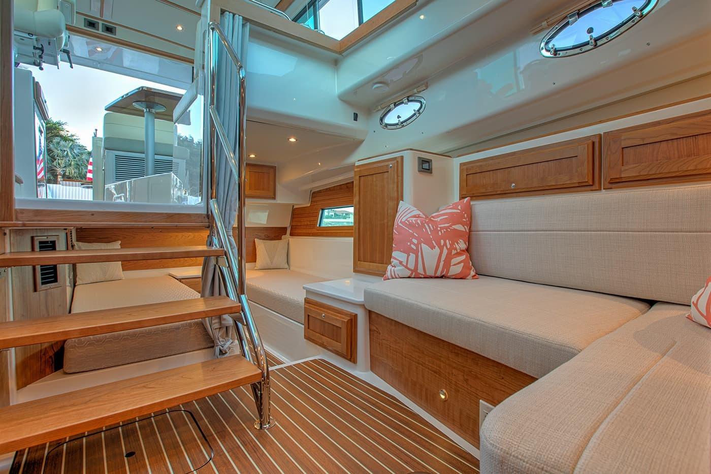 Luxurious interior of 2027 Back Cove 39O yacht with elegant wood finishes and cozy seating.