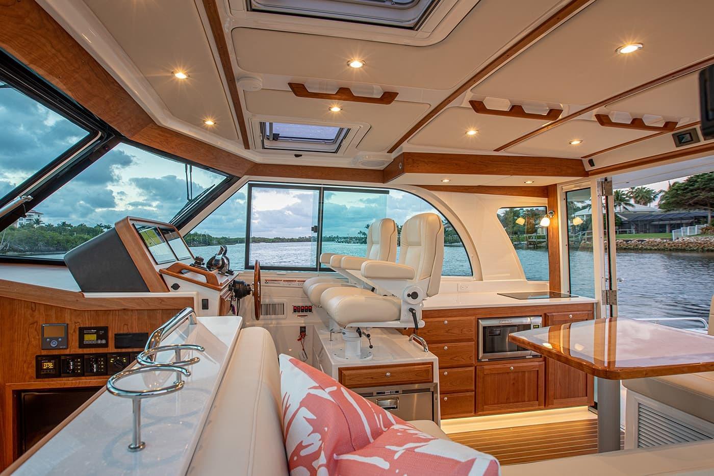 Luxurious interior of 2027 Back Cove 39O yacht with elegant seating and panoramic windows.