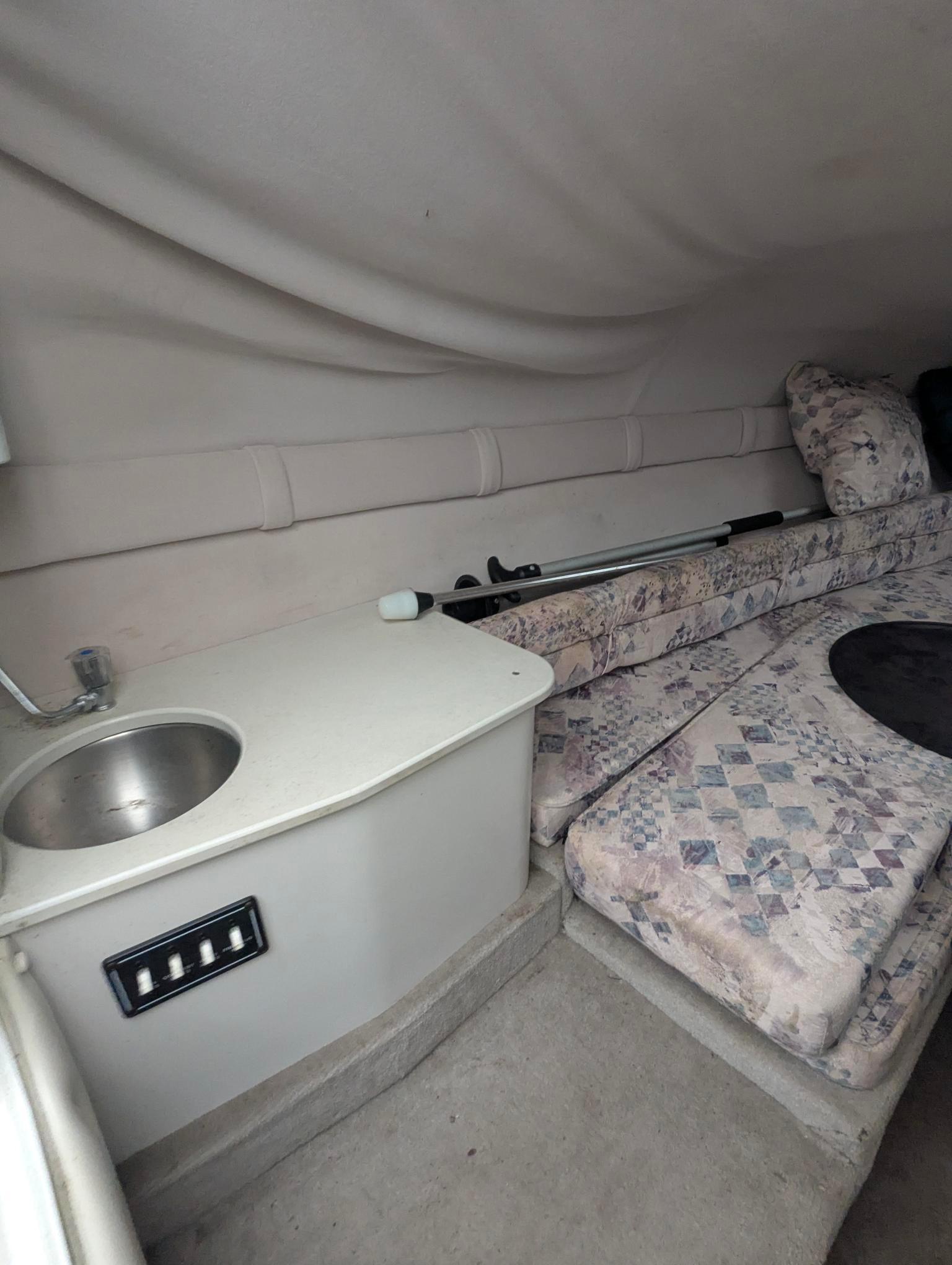 1999 Crownline 266 CCR cabin interior with sink and patterned seating.